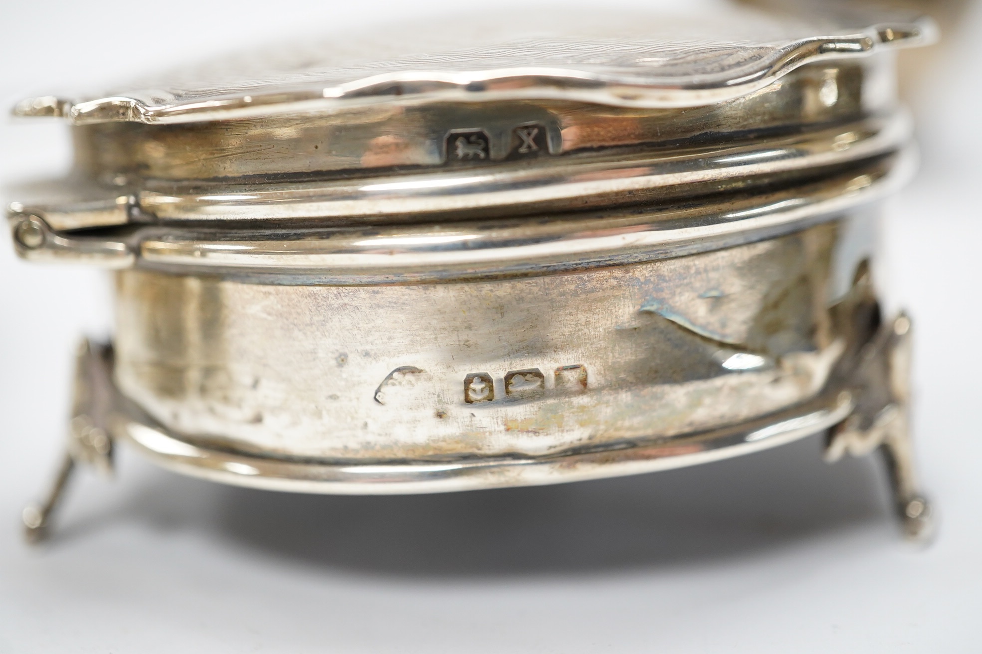 Two George V silver mounted trinket boxes, including rectangular by A & J Zimmerman & Co, 10.7cm, together with a white metal soup ladle. Condition - poor to fair